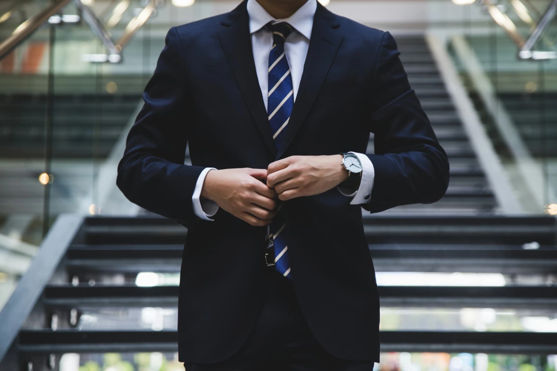 Man in a bespoke suit on staircase
